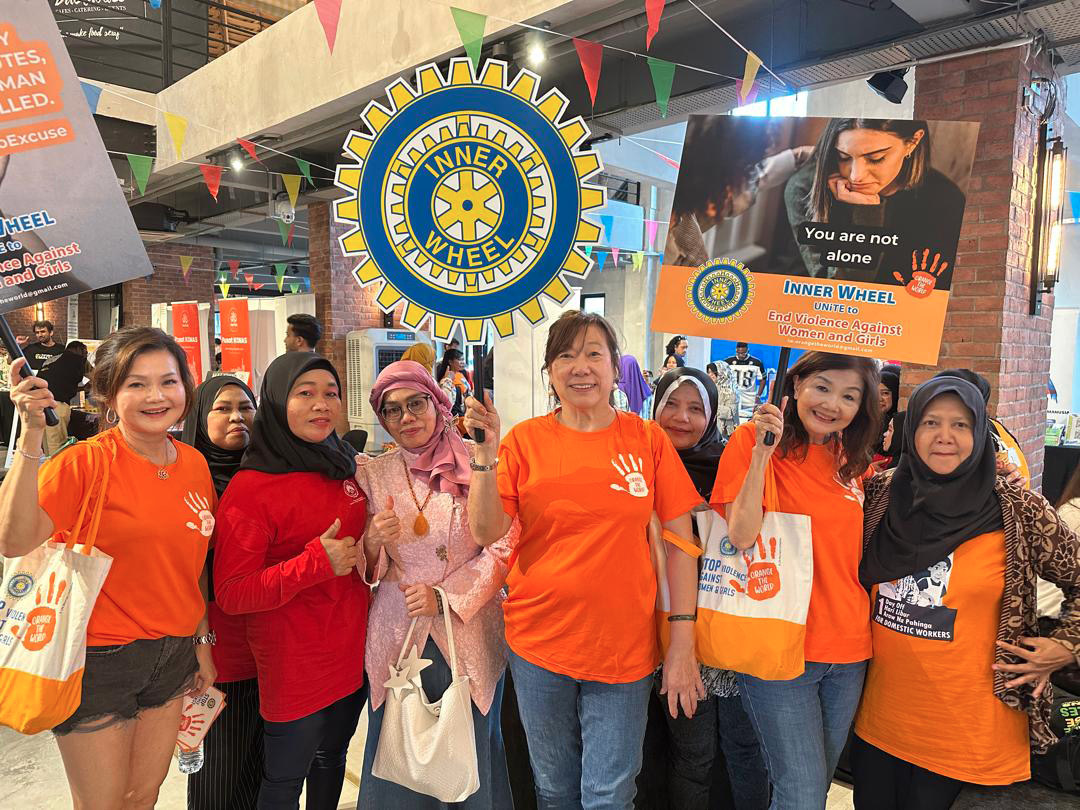 A group of people wearing orange shirts are standing together, some of them giving thumbs up. They are holding signs and bags.

AI generated content