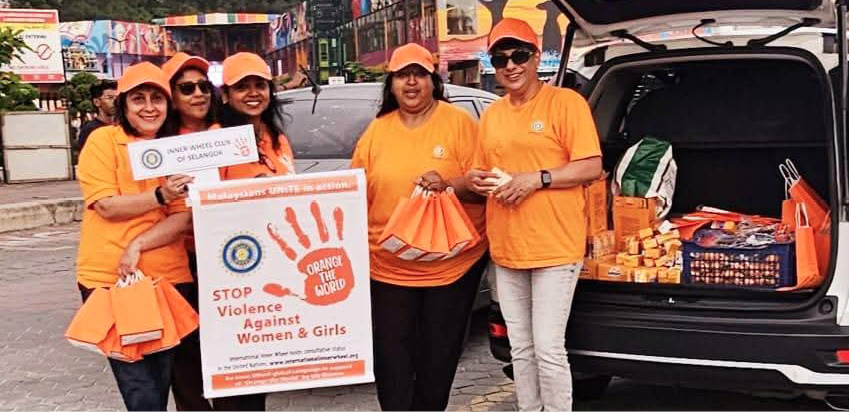 A group of women in orange shirts are standing next to a car with its trunk open. They are holding bags and a sign.
AI generated content