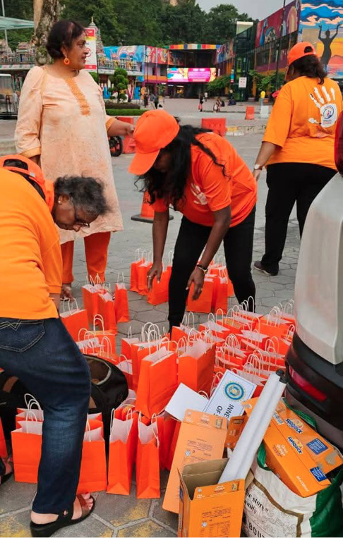 Three people are standing around a pile of orange bags.
AI generated content