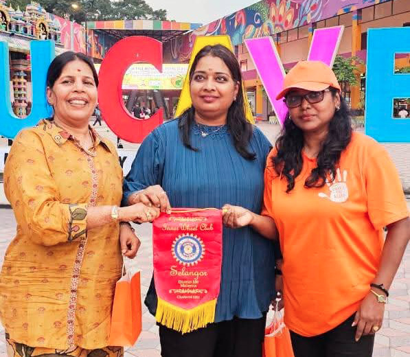 Three women are standing together, holding a red and white flag. They are posing for a picture, with one of the women wearing an orange shirt. The women are smiling, and the scene appears to be a celebration or gathering.
AI generated content