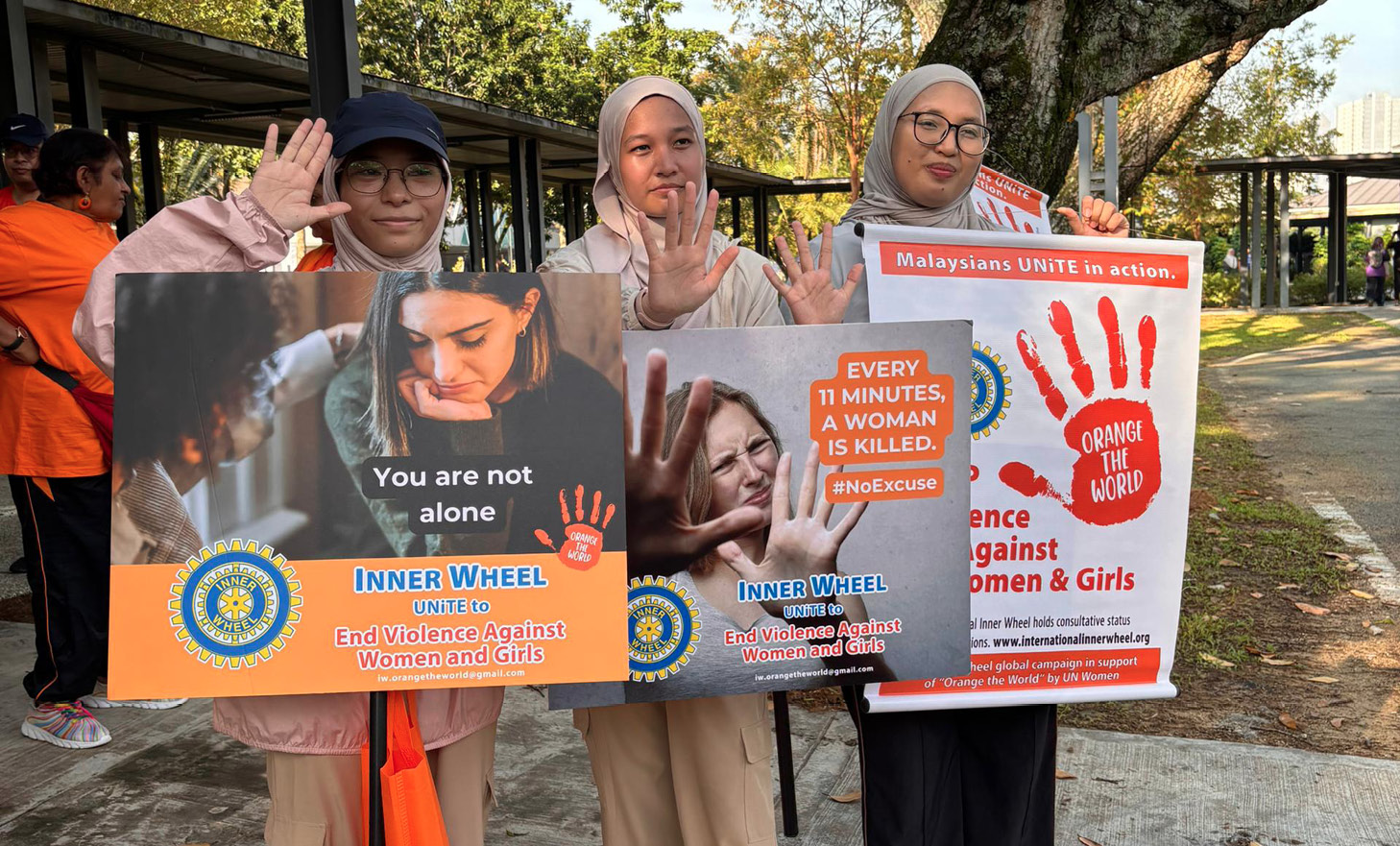 Three women are holding up signs in front of a building.

AI generated content