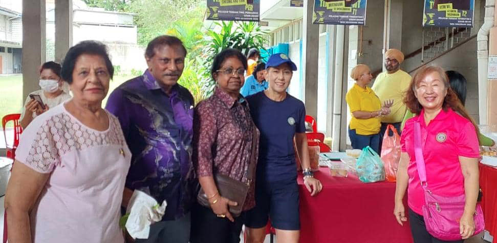 A group of people are standing in front of a table with food on it. They are posing for a picture.
AI generated content