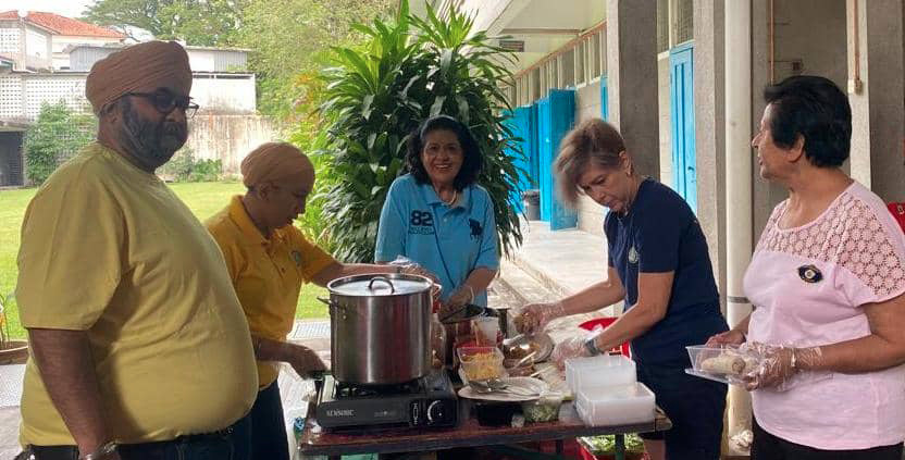 A group of people are gathered around a table with a pot on it. They are smiling and enjoying the event.
AI generated content