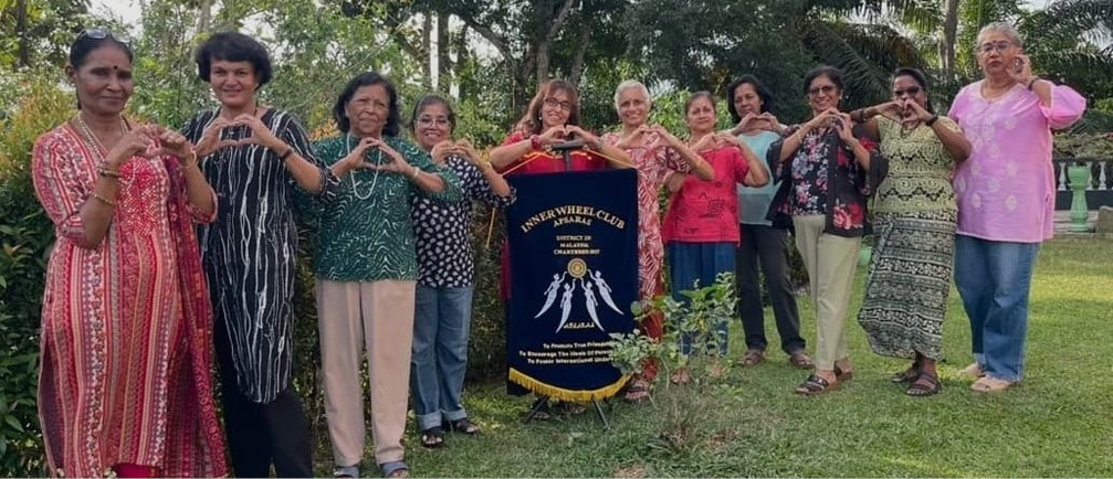 A group of women pose for a picture in front of a sign.
AI generated content