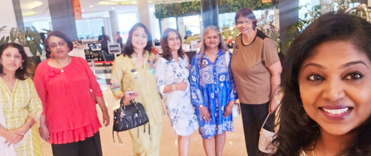 A group of women posing for a picture in a room with potted plants.
AI generated content