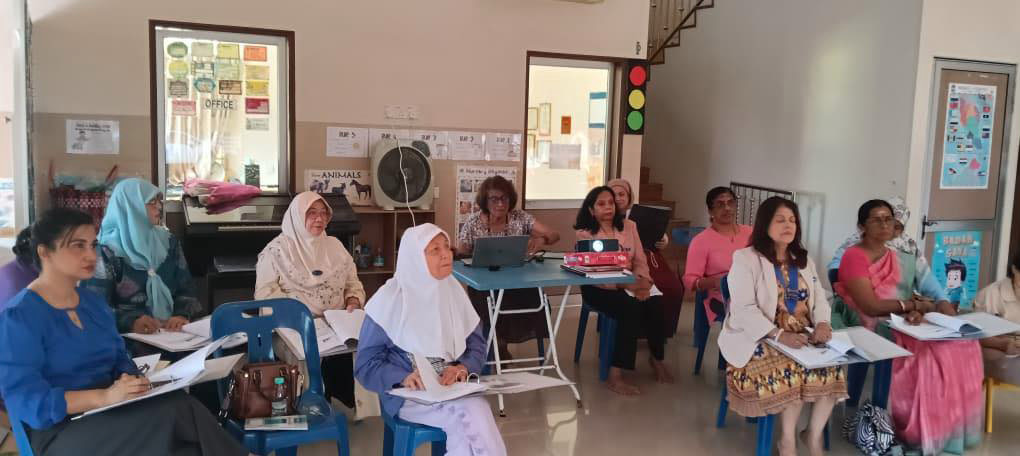A group of women are sitting in a circle, engaged in a discussion. They are wearing headscarves and are seated on chairs. There are several books on the table in front of them.

AI generated content