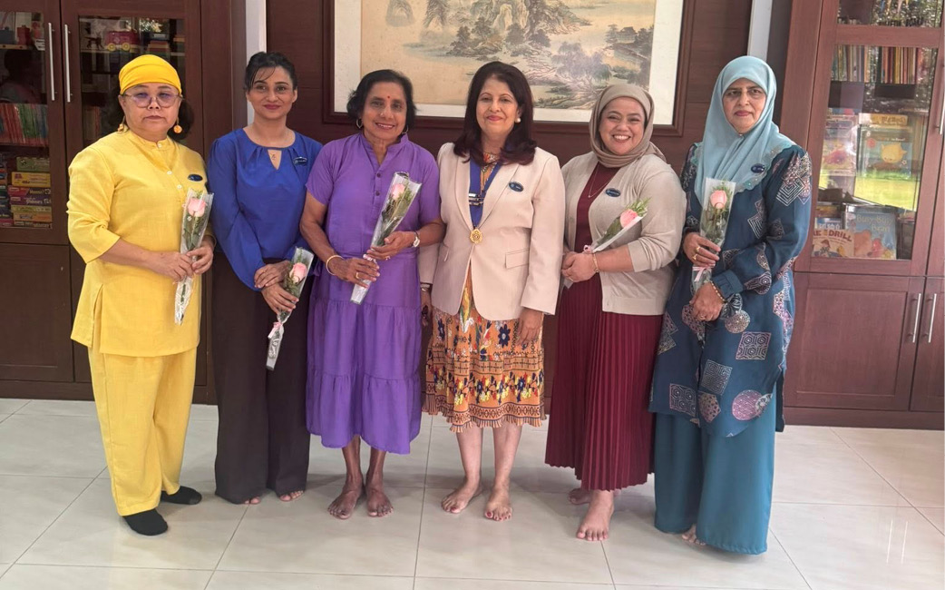 A group of women in a room holding flowers.

AI generated content
