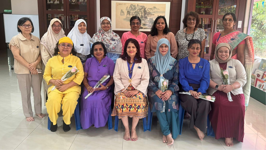 A group of women are sitting on chairs, posing for a picture. They are wearing colorful outfits and some are holding flowers.

AI generated content
