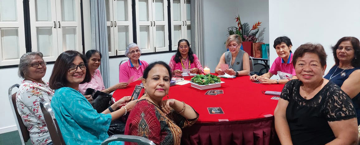 A group of women are sitting around a table, engaged in conversation.
AI generated content