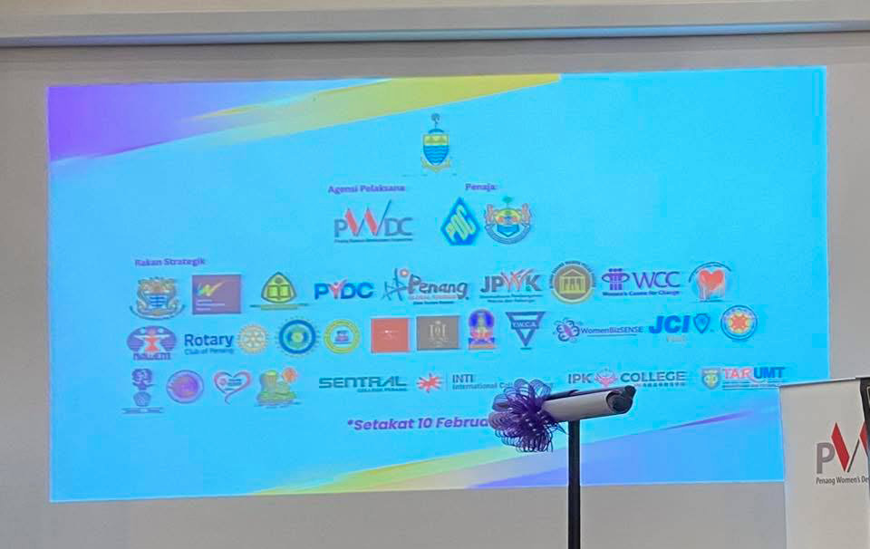 A projector screen displays a list of logos, including those for PwC, JCI, and Rotary.

AI generated content