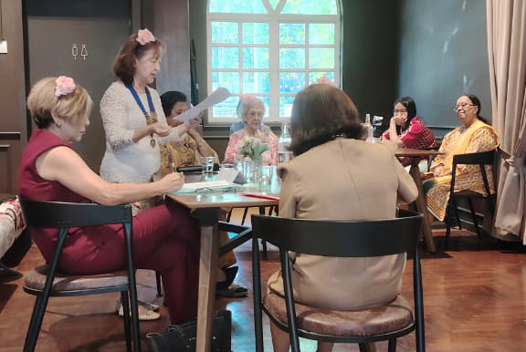 A group of people are sitting around a table in a room.

AI generated content