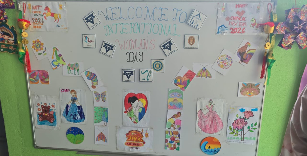 A decorated board with colorful drawings, cutouts, and handwritten text welcoming International Women's Day with various artistic designs and celebratory elements.

Description generated by AI
