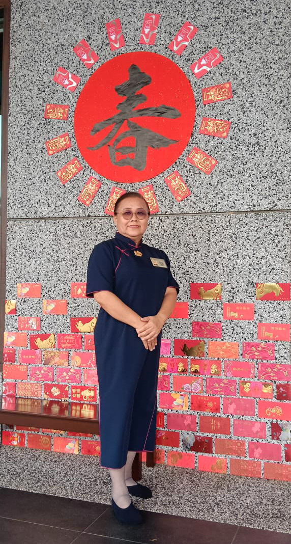 A woman in a blue dress stands in front of a wall with a red and white sign.

AI generated content
