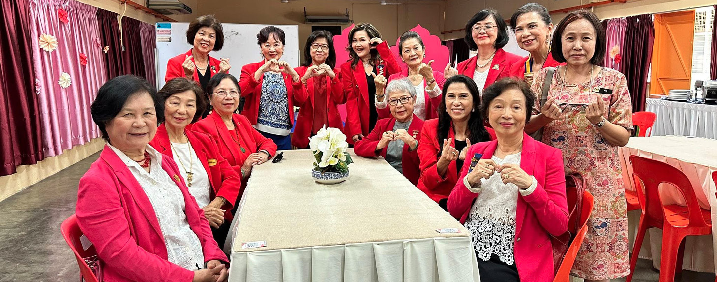 A group of women wearing red jackets are sitting around a table.

AI generated content