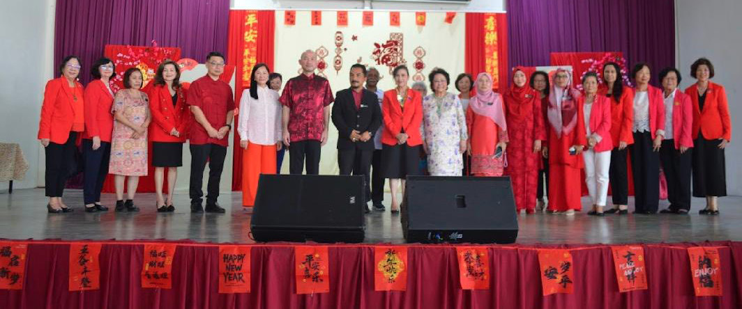 A group of people wearing red clothing are standing on a stage in front of a microphone.

AI generated content