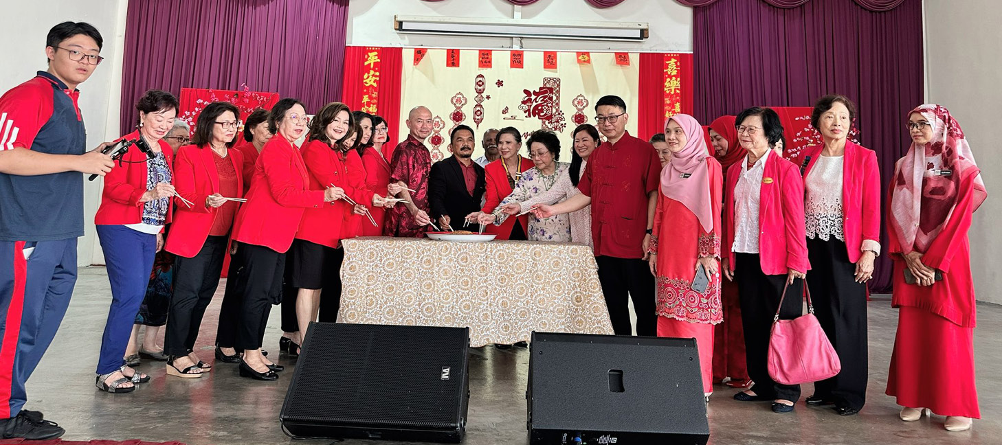 A group of people in red shirts are standing in front of a table with a cake on it.

AI generated content