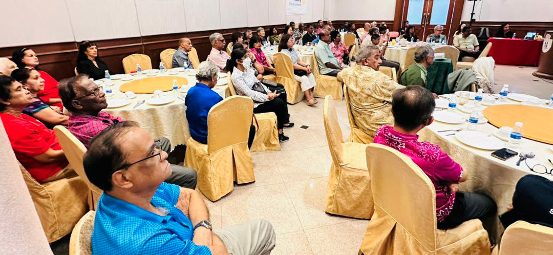 A group of adults seated around round tables in a conference room attentively listening to a speaker at a Rotary Club of Senawang event.
Description generated by AI