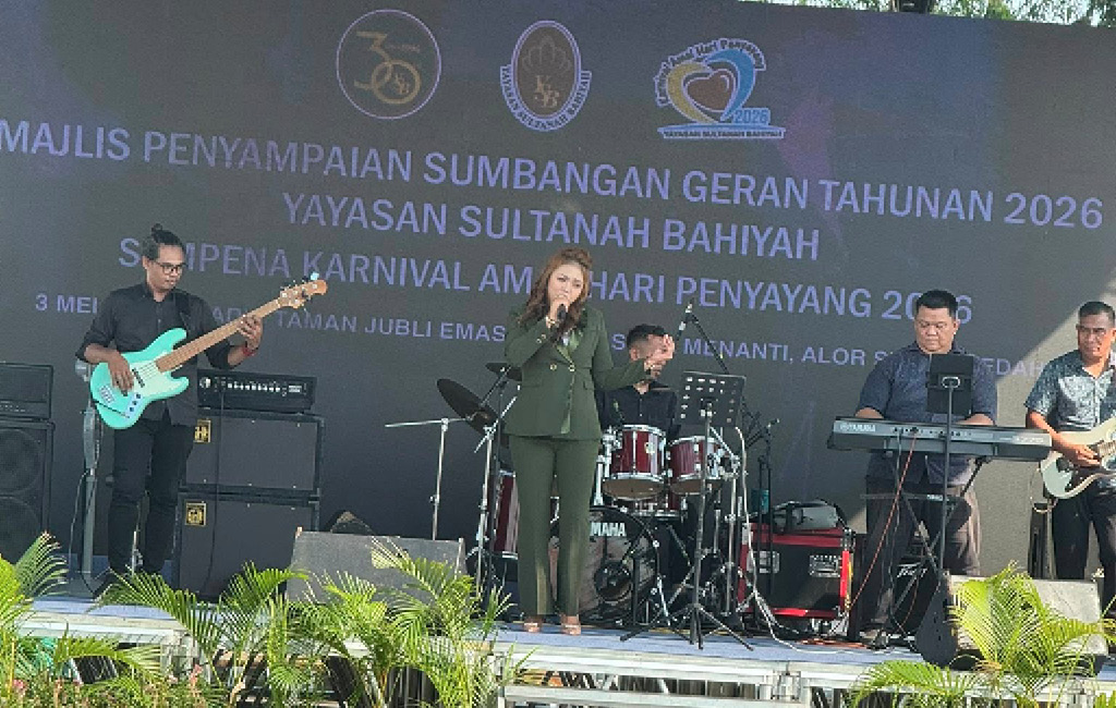 People are performing music on a stage decorated with plants and a backdrop displaying text about an annual grant presentation and carnival event.

Description generated by AI